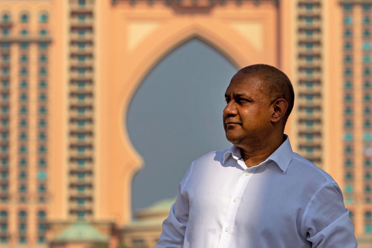 1228918469 Sanjay Shah, chief executive officer of Elysium Global Ltd., poses for a photograph in front of the Atlantis Hotel on the Palm Jumeriah in Dubai, United Arab Emirates, on Tuesday, Sept. 29, 2020. Shah charted a spectacular rise from trading-floor obscurity to amassing as much as $700 million and a property portfolio that stretched from Regents Park in his native London to Dubai. Photographer: Christopher Pike/Bloomberg via Getty Images