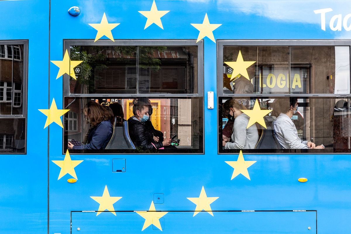 Passengers in protective face masks are seen in a tram painted with European Union colours  as the number of cases drops significantly in Krakow's Old Town, Poland on May 28, 2021. Coronavirus †lockdown is partially lifted as Poland managed to vaccinate about 15 million people and the number of Covid cases is low. Pubs and restaurants can now host outdoor guests and people do not need to wear face masks outdoors. (Photo by Dominika Zarzycka/NurPhoto) (Photo by Dominika Zarzycka / NurPhoto / NurPhoto via AFP)