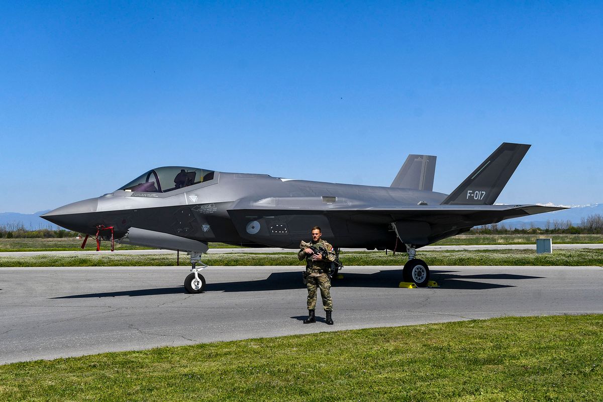 Dutch soldier guards Lockheed Martin F-35 Lightning II jet at Graf Ignatievo Air Force Base near Plovdiv, Bulgaria on 14 April, 2022.Four Lockheed Martin F-35 Lightning II jets were relocated by  Netherlands Air Force to the Republic of Bulgaria for the forthcoming implementation of a mission for enhanced joint protection of Bulgarian airspace. (Photo by Georgi Paleykov/NurPhoto) (Photo by Georgi Paleykov / NurPhoto / NurPhoto via AFP)
