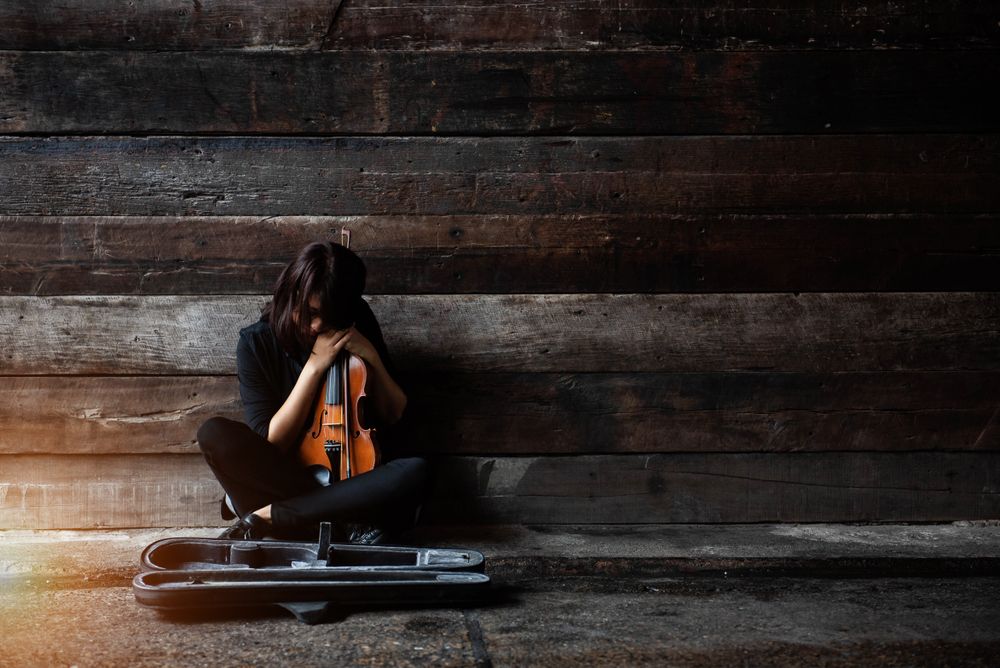 The,Lady,Is,Sitting,On,Grunge,Surface,Cement,Floor,hold,Violin