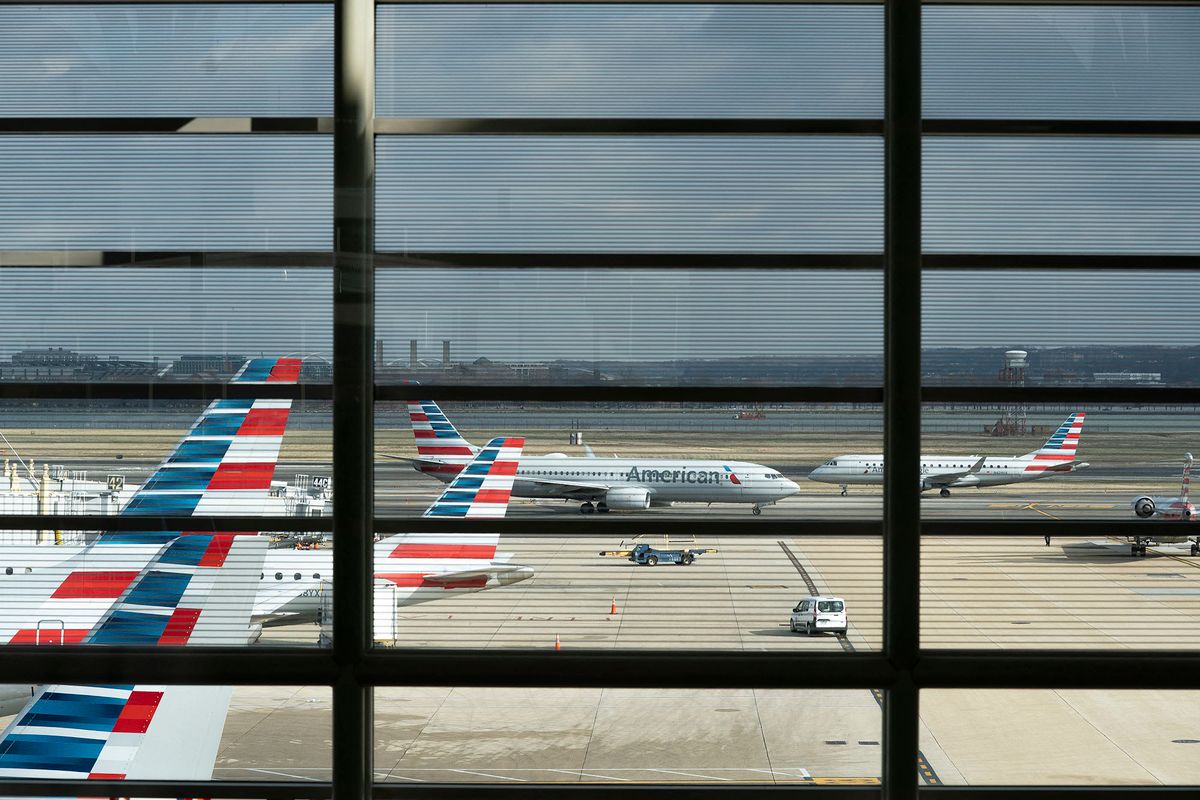 American Airlines planes sit at Ronald Reagan Washington National Airport in Arlington, Virginia, on January 18, 2022. - The chief executives of the largest US airlines warned of a "catastrophic disruption" to travel and shipping operations if telecommunication firms roll out their 5G technology as planned on January 19 without limiting the technology near US airports. Verizon and AT&T have already twice delayed the launch of their new C-Band 5G service, due to warnings from airlines and aircraft manufacturers concerned that the new system might interfere with the devices planes use to measure altitude. (Photo by Stefani Reynolds / AFP)