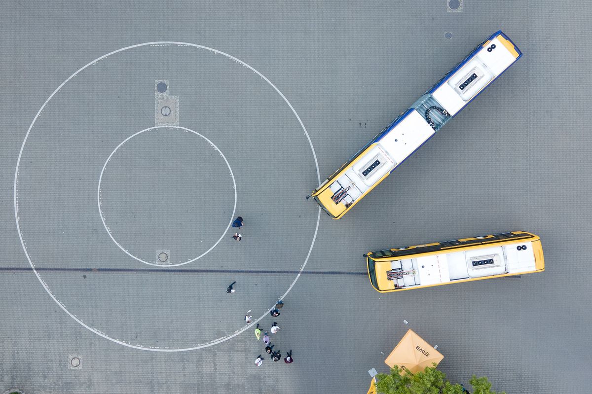 02 June 2022, Saxony, Dresden: Two electric buses of the Dresdner Verkehrsbetriebe (DVB) stand during a press event at the bus depot Gruna (aerial photo with a drone). By August 2023, a total of 20 electric buses will be in operation in DVB's route network. Photo: Sebastian Kahnert/dpa (Photo by Sebastian Kahnert / DPA / dpa Picture-Alliance via AFP)