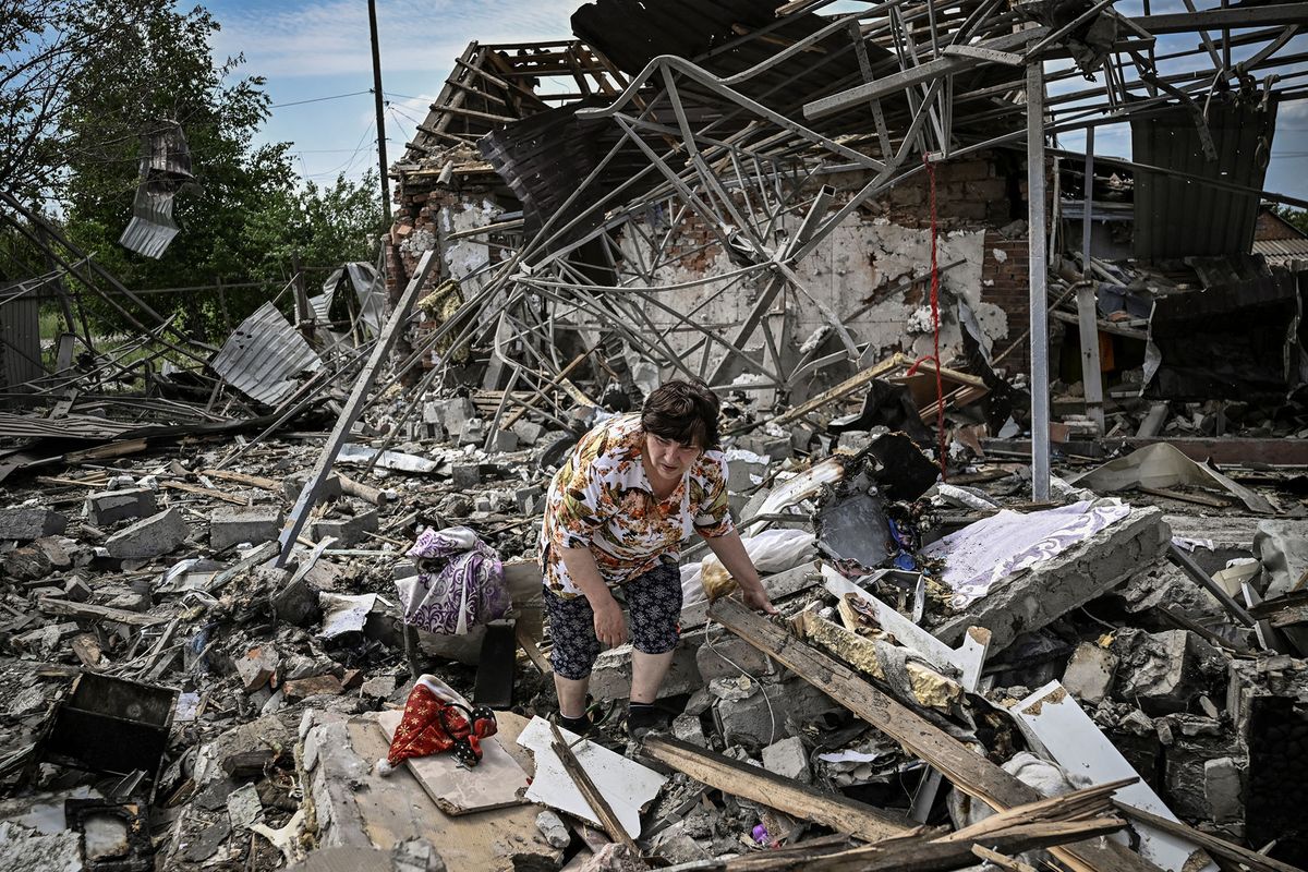 Residents look for belongings in the rubble of their home after a strike destoyed three houses in the city of Sloviansk in the eastern Ukrainian region of Donbas on June 1, 2022. (Photo by ARIS MESSINIS / AFP)