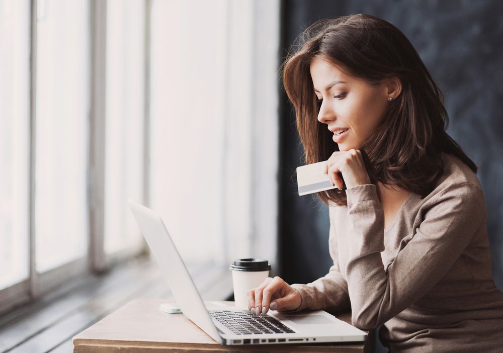 Young,Woman,Holding,Credit,Card,And,Using,Laptop,Computer.,Businesswoman