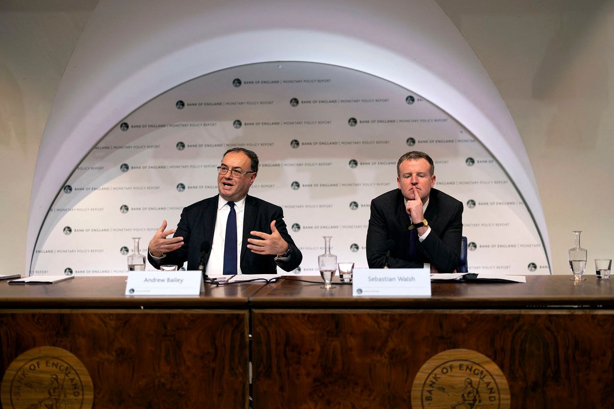 Governor of the Bank of England Andrew Bailey (L) speaks alongside Chief Press Officer Sebastian Walsh (R) during the Monetary Policy Report Press Conference at The Bank of England in the City of London on February 3, 2022. - The Bank of England on Thursday lifted its main interest rate for the second time in a row in a bid to tackle decades-high inflation. (Photo by Dan Kitwood / POOL / AFP)