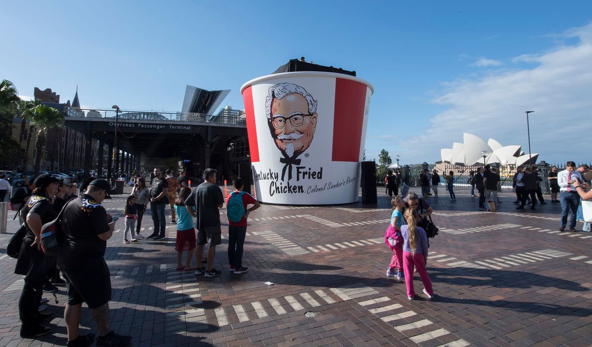 KFC 951744192 SYDNEY, AUSTRALIA - APRIL 27:  A gigantic Kentucky Fried Chicken bucket to celebrate it's 50th birthday in Australia measuring six metres tall and seven metres wide on April 27, 2018 in Sydney, Australia. The first Kentucky Fried Chicken store opened in Australia 50 years ago in Guildford, New South Wales on April 27, 1968. There are now 640 stores around Australia, employing approx 35,000 people and serving more than two million customers weekly.  (Photo by James D. Morgan/Getty Images)