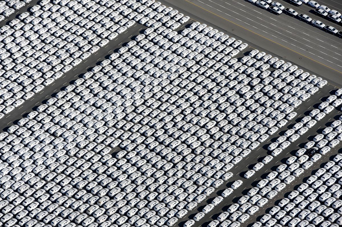 New cars of German car maker Volkswagen (VW) stand ready for shipping next to the Volkswagen plant in Emden, northwestern Germany, on September 30, 2015. Volkswagen, the world's biggest carmaker by sales, has admitted that up to 11 million diesel cars worldwide are fitted with devices that can switch on pollution controls when they detect the car is undergoing testing.     AFP PHOTO / DPA / INGO WAGNER   +++   GERMANY OUT   +++ (Photo by INGO WAGNER / DPA / AFP)