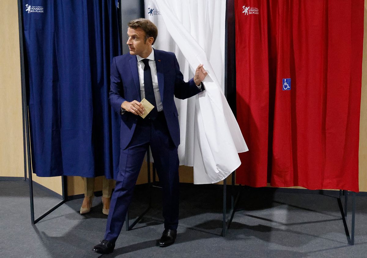 France's President Emmanuel Macron leaves the polling booth to casts his vote in French parliamentary elections at a polling station in Le Touquet, northern France on June 12, 2022. (Photo by Ludovic MARIN / POOL / AFP)
