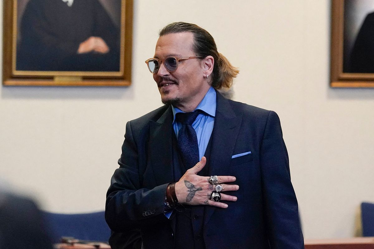 (FILES) In this file photo taken on May 27, 2022 Actor Johnny Depp gestures to spectators in court after closing arguments at the Fairfax County Circuit Courthouse in Fairfax, Virginia. - A US jury found June 1, 2022 that actress Amber Heard had made defamatory claims of abuse against her ex-husband Johnny Depp, and awarded him $15 million in damages. (Photo by Steve Helber / POOL / AFP)