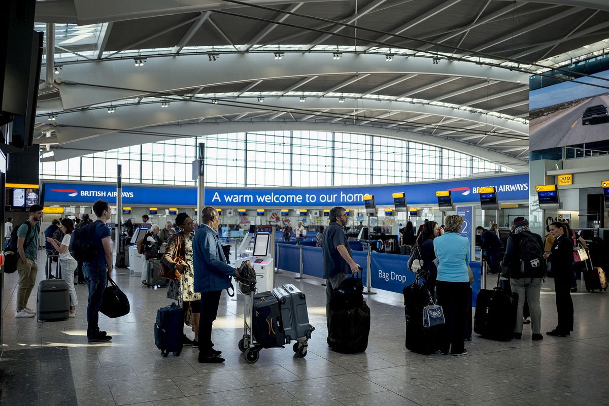 Passengers queue to check-in for their flights at Heathrow Airport's Terminal 5 in west London, on September 13, 2019. - British Airways has cancelled all its scheduled UK flights for September 27, when company pilots will again strike in a long-running row over pay. (Photo by Tolga Akmen / AFP)
