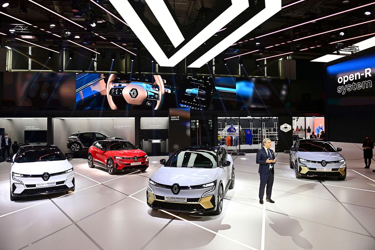 French carmaker Renault CEO Luca de Meo stands amid new Renault Megane E-Tech electric cars  during a press presentation at the International Motor Show (IAA) Germany, on September 6, 2021 in Munich. - Germany's revamped IAA auto show, one of the world's largest, from September 7 to 12, 2021 for a celebration of all things car-related, but climate concerns and pandemic woes threaten to spoil the party. Historically held in Frankfurt, the IAA will for the first time take place in the Bavarian city of Munich as part of efforts to revive the event. (Photo by Tobias SCHWARZ / AFP)