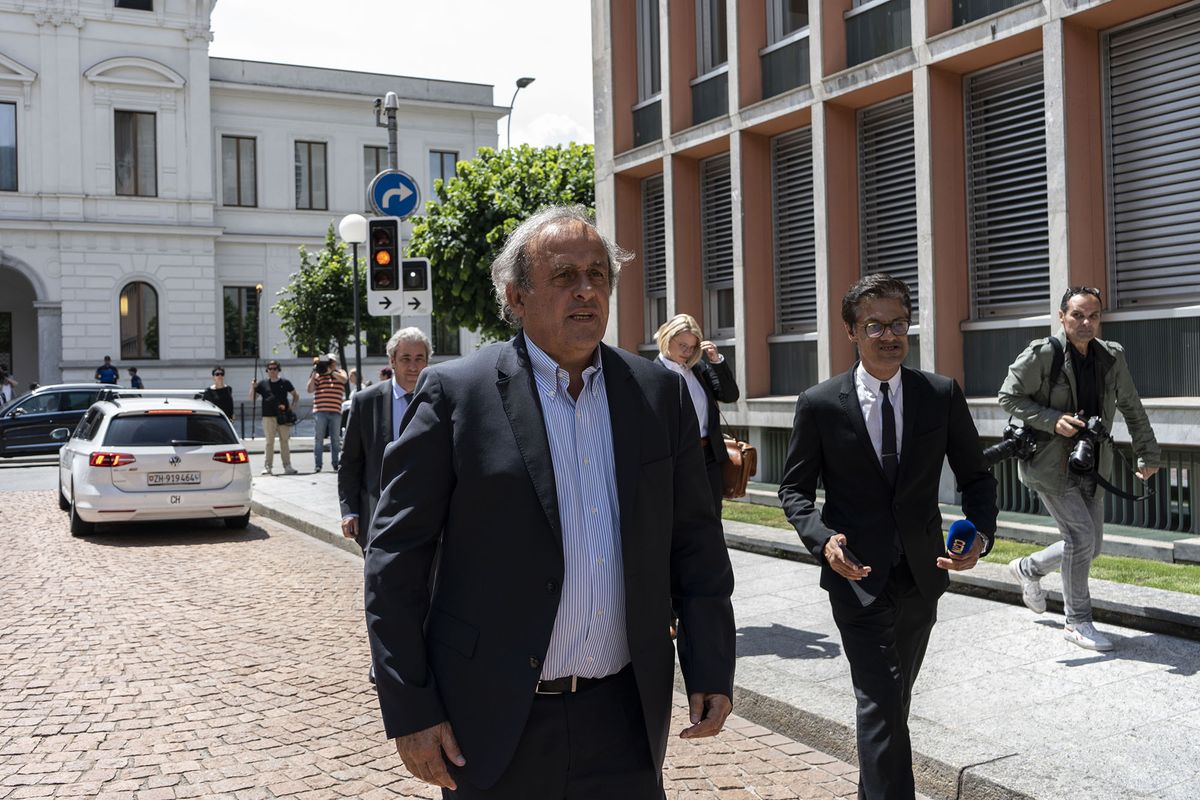 1241174705 Michel Platini, former head of UEFA, center, leaves after attending a trial hearing at the Swiss Federal Criminal Court in Bellinzona, Switzerland, on Wednesday, June 8, 2022. Ex-FIFA boss Sepp Blatter and his former heir apparent Platini are set to appear in a Swiss court on Wednesday accused of corruption in a case that revives past scandals ahead of this years controversial World Cup in Qatar. Photographer: Francesca Volpi/Bloomberg via Getty Images