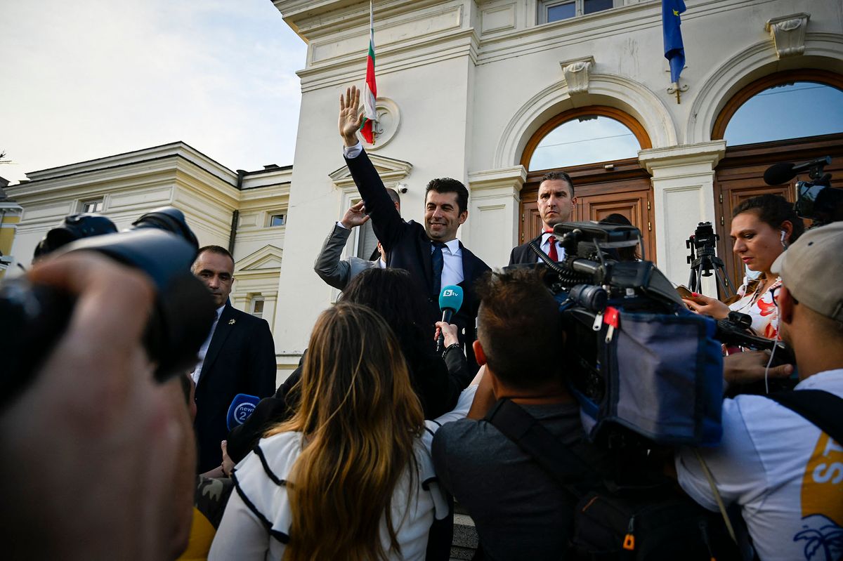 Bulgaria's Prime Minister Kiril Petkov (C) waves to supporters during a demonstration in support of the government after a successful no-confidence vote in front of the Bulgarian Parliament in Sofia on June 22, 2022. - Bulgaria's coalition government collapsed after just six months when it lost a vote of confidence among MPs, bringing fresh political turmoil and the increased likelihood of an early general election. (Photo by Nikolay DOYCHINOV / AFP)