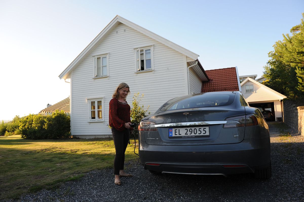 1041936710 Nina Haug Eide charges her Tesla electric car at her house in Son, Norway, 03 August 2015. Photo: Sigrid Harms/dpa | usage worldwide   (Photo by Sigrid Harms/picture alliance via Getty Images)