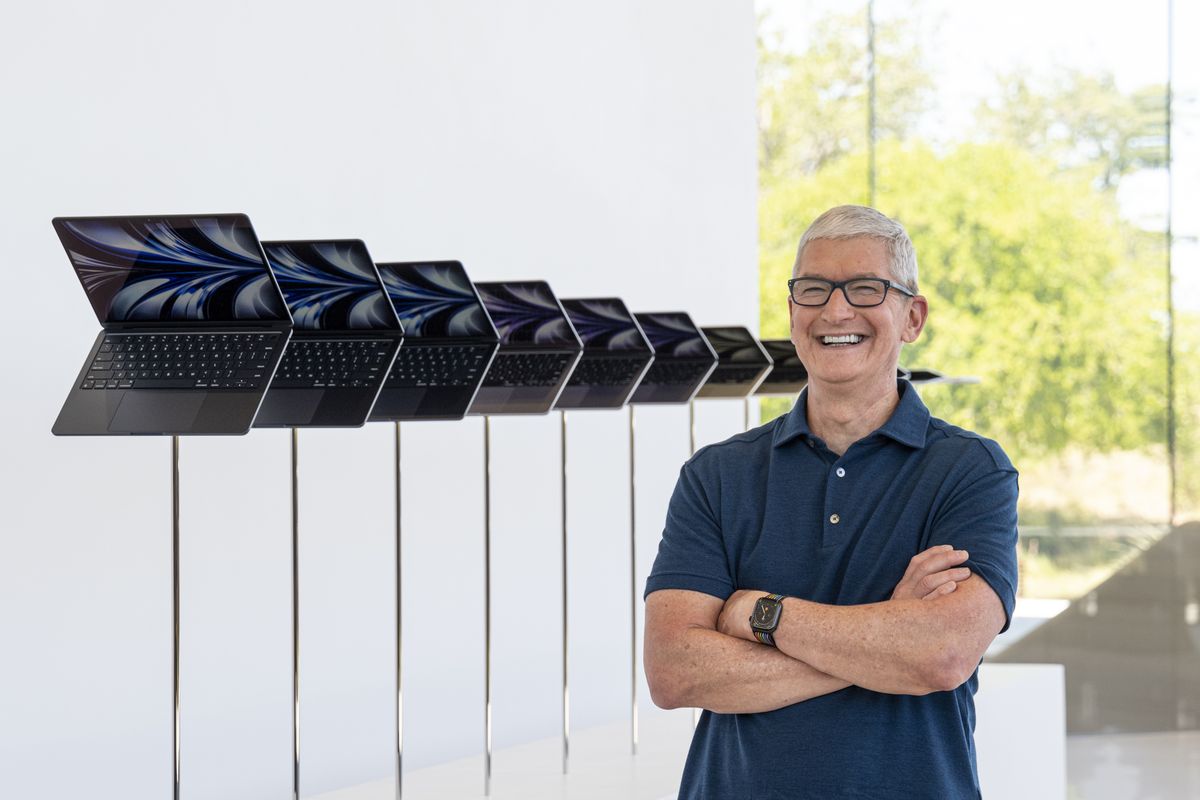 Tim Cook, chief executive officer of Apple Inc., next to a display of the new MacBook Air laptop computer during the Apple Worldwide Developers Conference at Apple Park campus in Cupertino, California, US, on Monday, June 6, 2022. Apple unveiled the most significant overhaul to its popular MacBook Air laptop in more than a decade, bringing a fresh design, new colors and a speedier M2 processor from its homegrown chip line. Photographer: David Paul Morris/Bloomberg via Getty Images