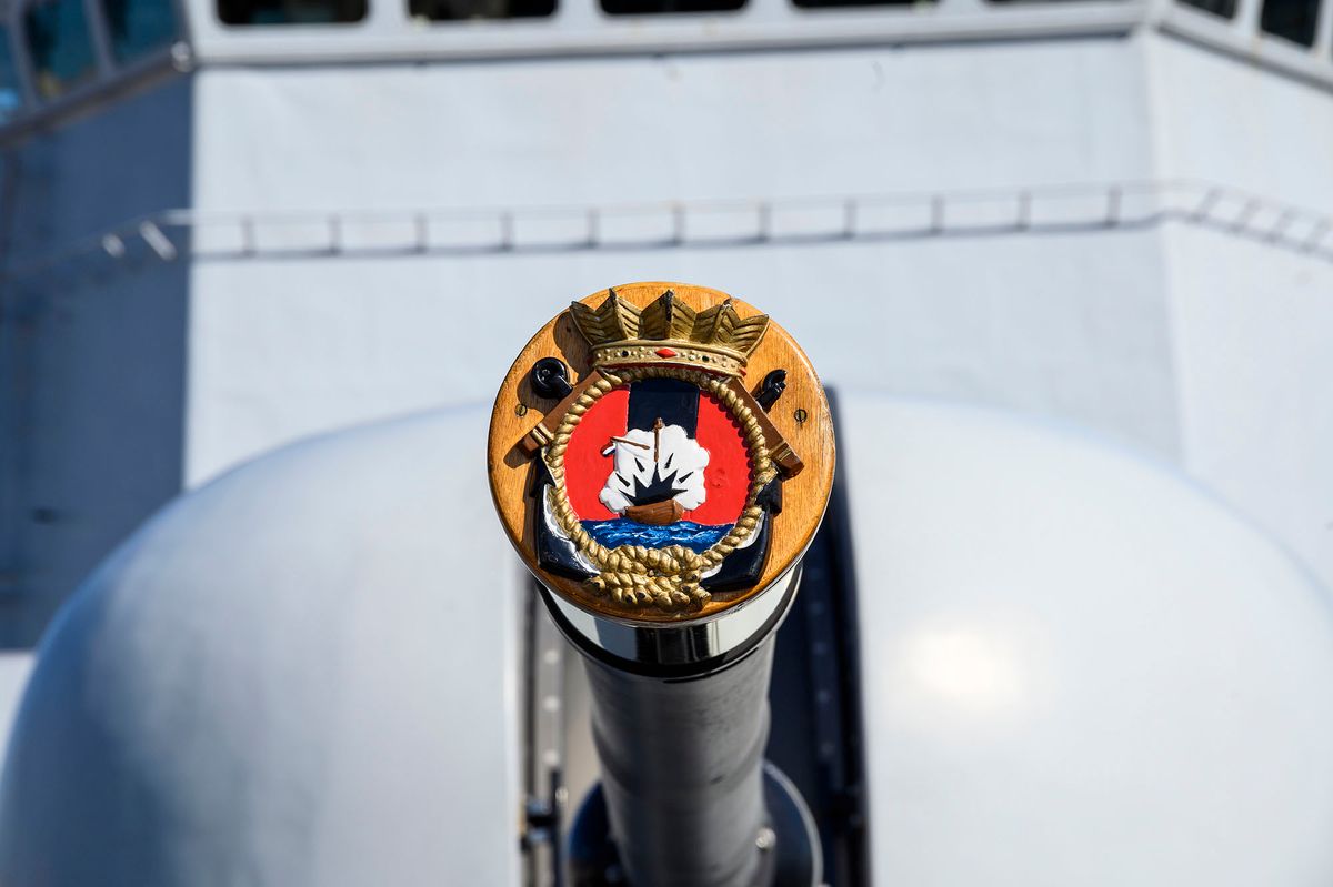 1183421824 LISBON, PORTUGAL - OCTOBER 25: A decorated gun cap protects the Oto Melara 76 mm anti-air/anti-surface gun of the Royal Netherlands Navy Karel Doorman-class frigate HNLMS Van Speijk, moored at Cais Rocha Conde de Óbidos during a three-day visit by Standing NATO Maritime Group One - SNMG1 Naval Force ships on October 25, 2019 in Lisbon, Portugal. SNMG1 is currently composed of Dutch, Norwegian, Belgian, U.S. and Portuguese vessels aiming to ensure continued maritime capacity and contribute to the security of the Atlantic Alliance member states. (Photo by Horacio Villalobos#Corbis/Corbis via Getty Images)