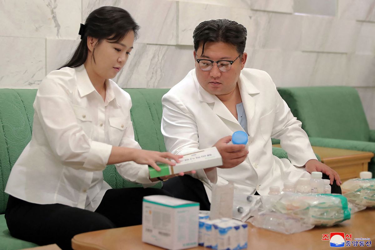 This picture taken on June 15, 2022 and released from North Korea's official Korean Central News Agency (KCNA) on June 16, 2022 shows North Korean leader Kim Jong Un and his wife Ri Sol ju send medicines prepared by his family to the Haeju City, South Hwanghae Province as regards the outbreak of an acute enteric epidemic, at an undisclosed location in North Korea. (Photo by KCNA VIA KNS / AFP)