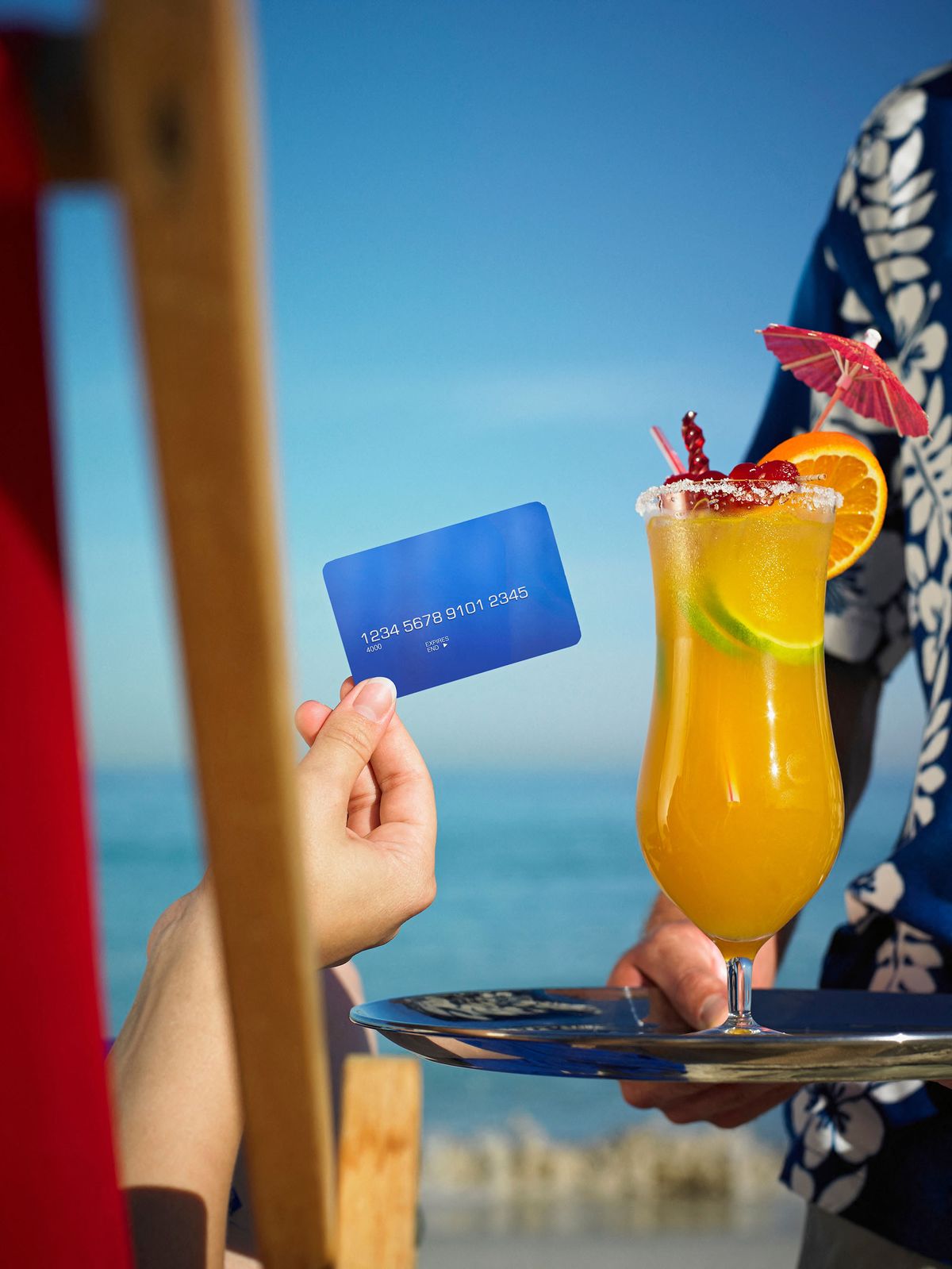 Person paying for drink with credit card (Photo by Adrian Weinbrecht / Cultura Creative / Cultura Creative via AFP)