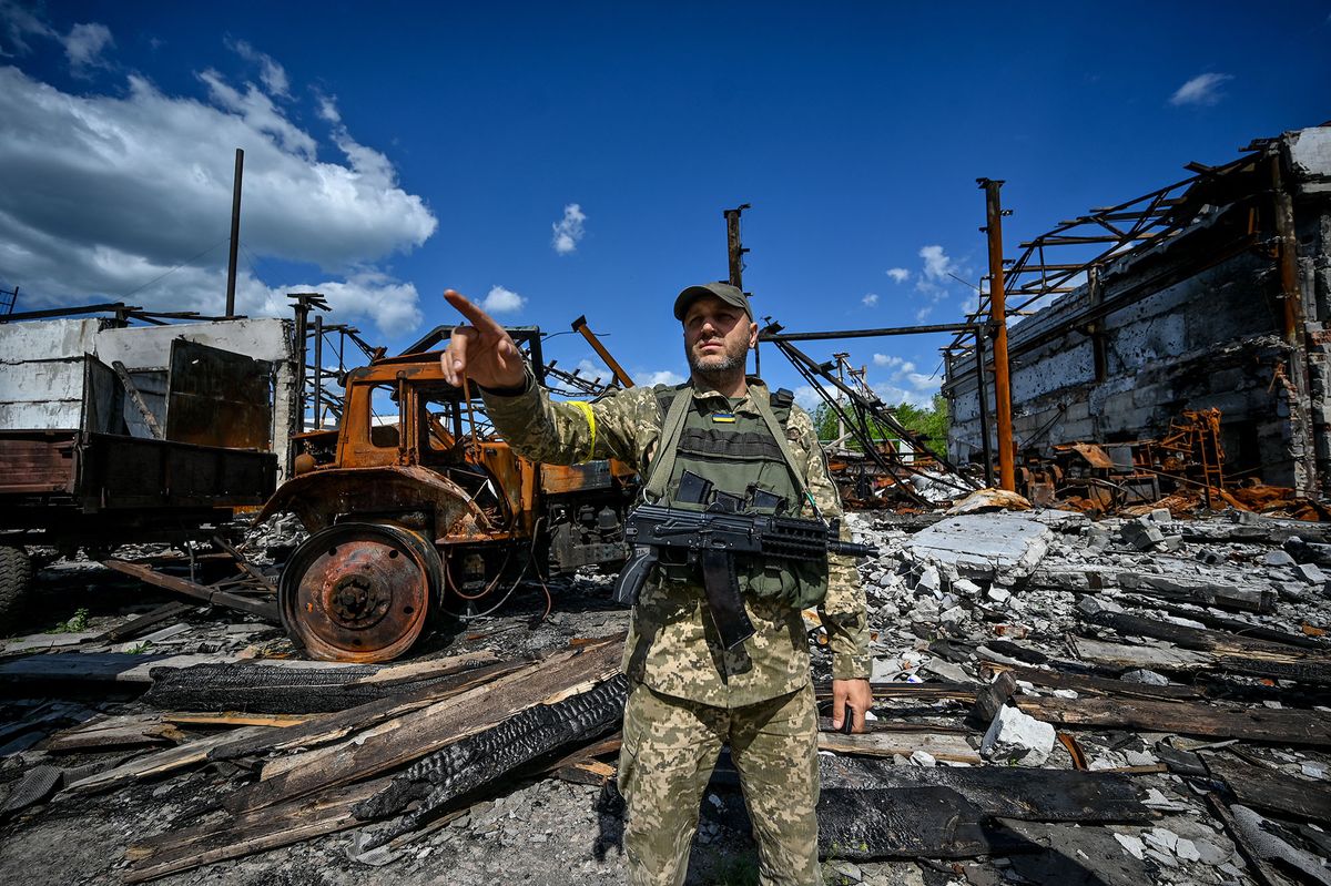 ZAPORIZHZHIA, UKRAINE - MAY 20: A soldier stands among damaged field following Russian attacks in Zaporizhzhia Oblast, Ukraine on May 20, 2022. Stringer / Anadolu Agency (Photo by STRINGER / ANADOLU AGENCY / Anadolu Agency via AFP)