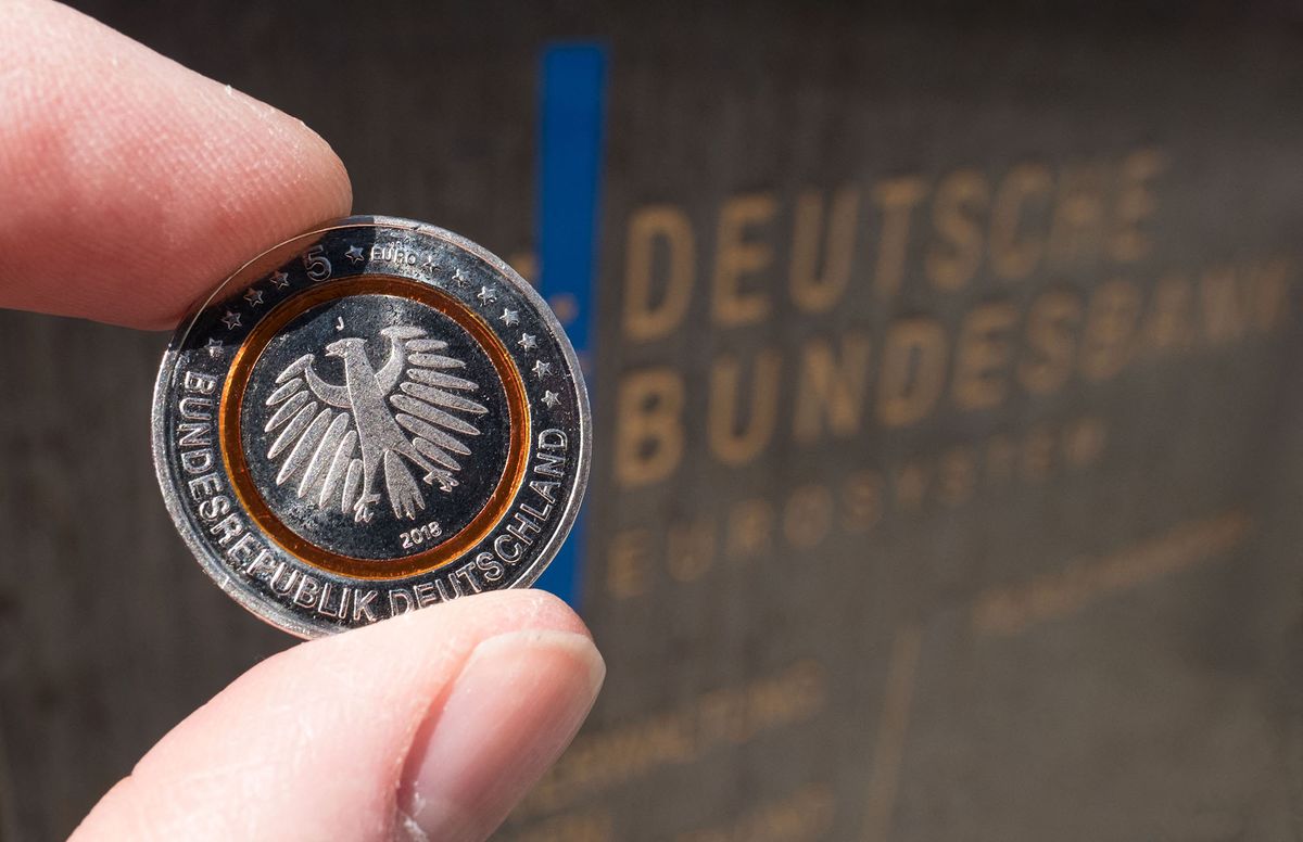 ILLUSTRATION - 19.04.2018, Lower Saxony, Hanover: The new 5-Euro-Sammlermunze (back) is held in front of the sign of the branch of the Deutsche Bundesbank in Hanover. Photo: Peter Steffen / dpa | usage worldwide (Photo by Peter Steffen / DPA / dpa Picture-Alliance via AFP)