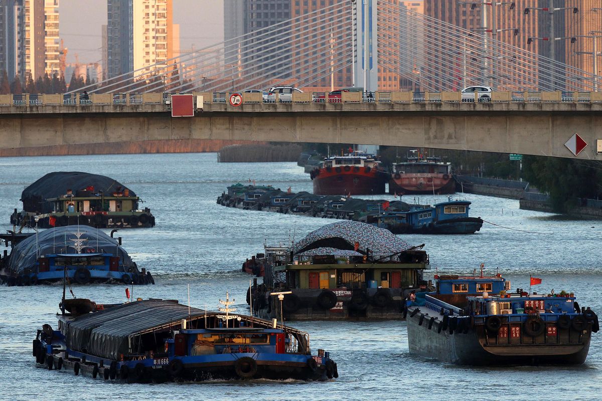 This photo taken on November 22, 2021 shows barges carrying coal on the Grand Canal in Huaian, in China's eastern Jiangsu province. (Photo by AFP) / China OUT