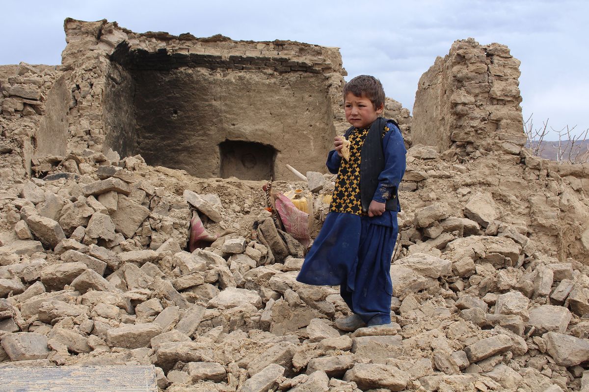 BADGHIS, AFGHANISTAN - JANUARY 18: A kid is seen on debris of a damaged house after the earthquake in Qala-e-Naw district of Badghis, Afghanistan on January 18, 2022. Ahmad Seddiqi / Anadolu Agency (Photo by Ahmad Seddiqi / ANADOLU AGENCY / Anadolu Agency via AFP)