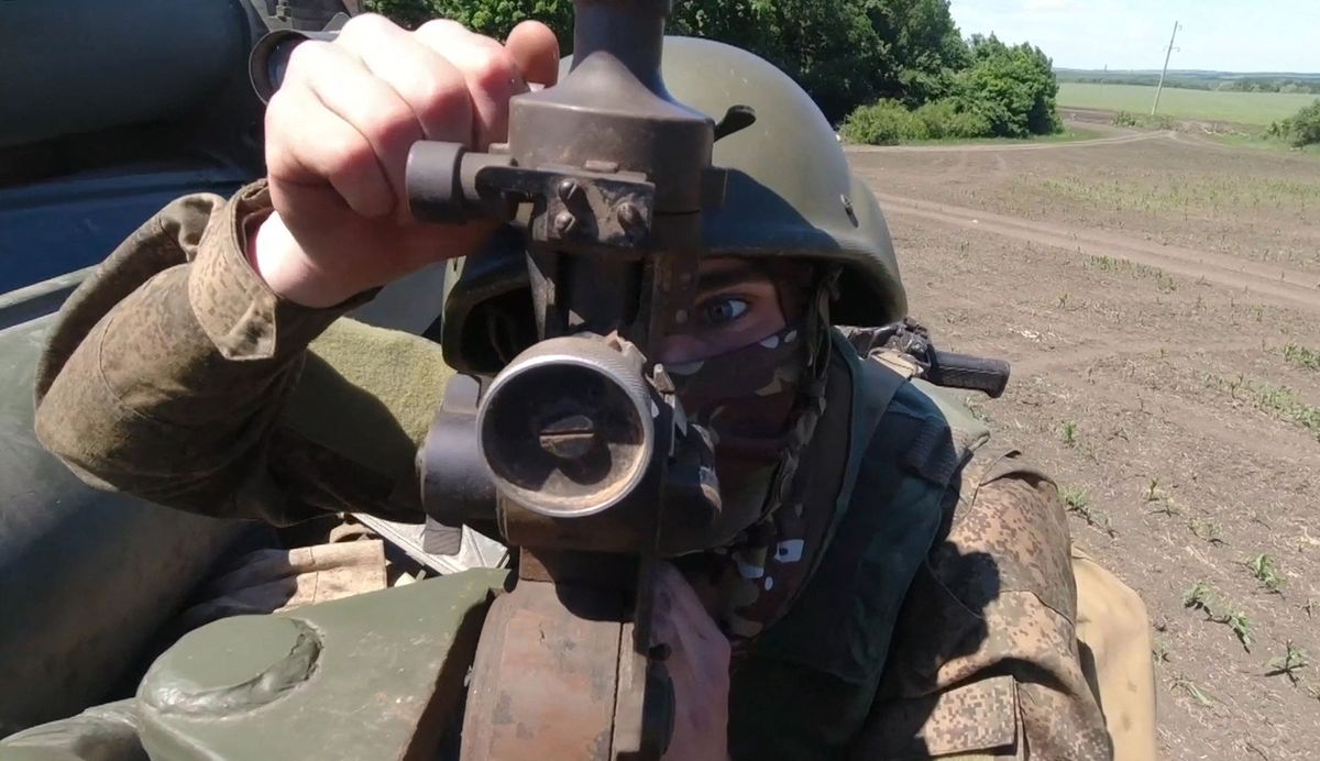 8214715 13.06.2022 In this handout video grab released by the Russian Defence Ministry, a Russian serviceman directs a landmark during the combat work of a Smerch heavy multiple rocket launcher in the course of Russia's military operation in Ukraine, at the unknown location. Editorial use only, no archive, no commercial use. Russian Defence Ministry (Photo by Russian Defence Ministry / Sputnik via AFP)