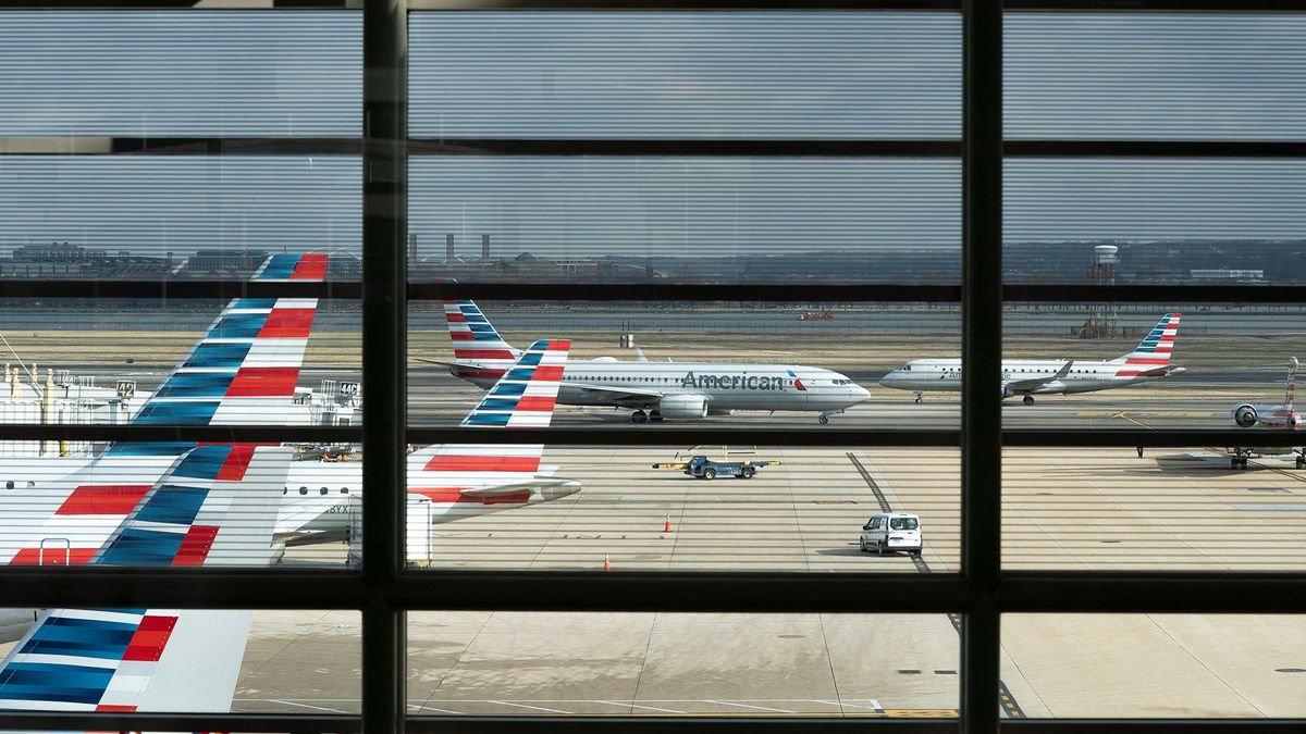 American Airlines planes sit at Ronald Reagan Washington National Airport in Arlington, Virginia, on January 18, 2022. - The chief executives of the largest US airlines warned of a "catastrophic disruption" to travel and shipping operations if telecommunication firms roll out their 5G technology as planned on January 19 without limiting the technology near US airports. Verizon and AT&T have already twice delayed the launch of their new C-Band 5G service, due to warnings from airlines and aircraft manufacturers concerned that the new system might interfere with the devices planes use to measure altitude. (Photo by Stefani Reynolds / AFP)