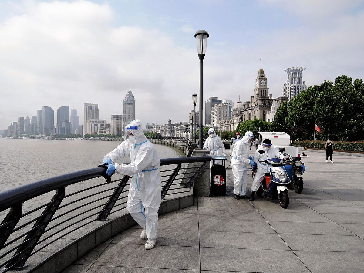 Staffs wearing protective gears disinfect fences at the Band in Shanghai, China on June 1, 2022. The city practically lifted 2-month lockdown due to the spread of Coronavirus COVID-19 infections on the same day.?( The Yomiuri Shimbun ) (Photo by Daisuek Kawase / Yomiuri / The Yomiuri Shimbun via AFP)