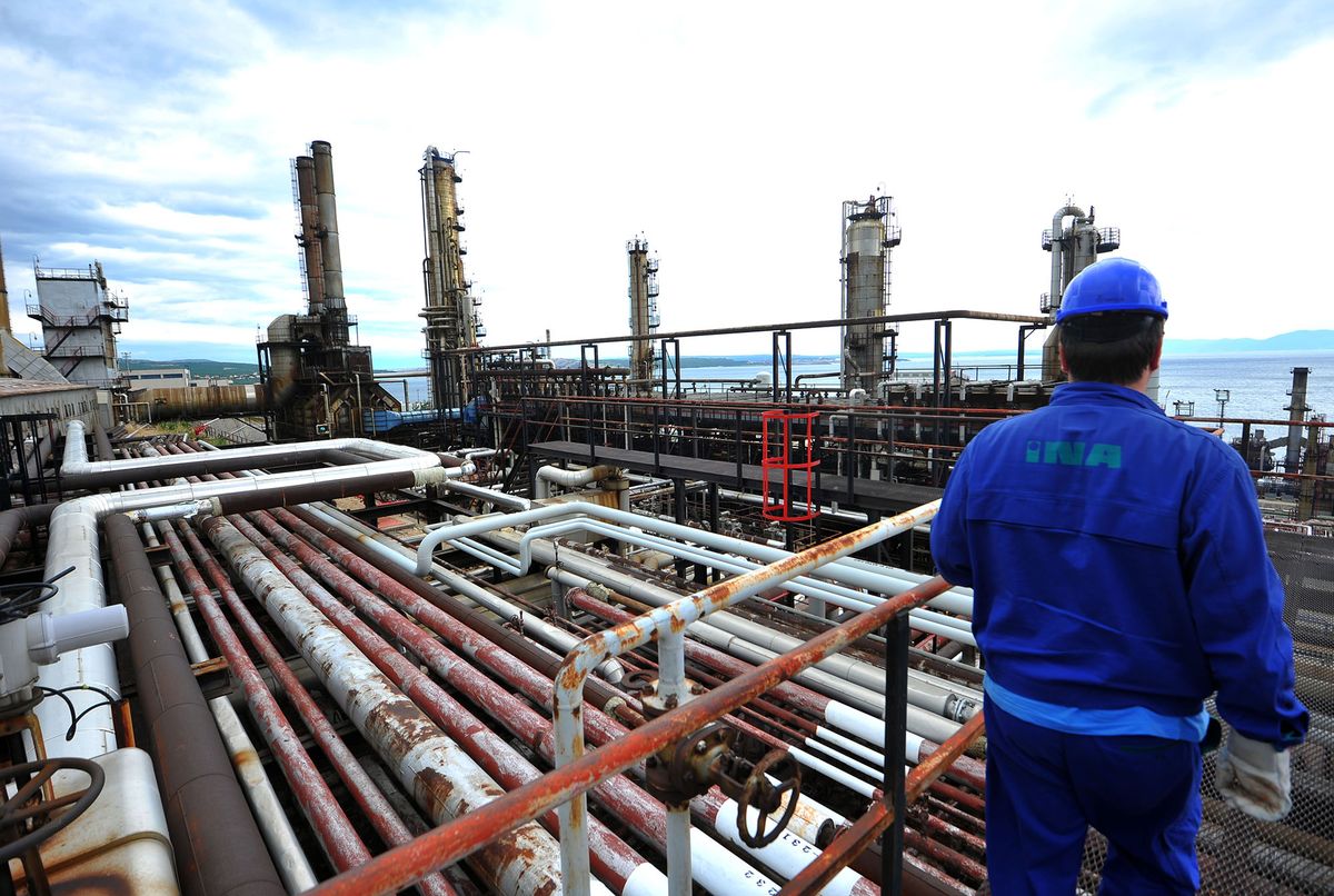 169398603 An employee stands on a platform above pipelines at the INA Industrije Nafte d.d. oil refinery on the shores of the Adriatic sea in Urinj, near Rijeka, Croatia, on Thursday, May 23, 2013. Croatia, whose economic development was stifled by Europe's bloodiest fighting since World War II, is trying to revive growth after four years of recession or stagnation. Photographer: Oliver Bunic/Bloomberg via Getty Images