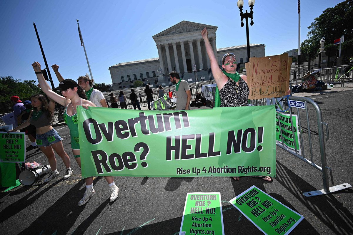 Pro-choice activists are seen outside of the US Supreme Court in Washington, DC on June 15, 2022. - A draft opinion leaked in May would have the conservative majority on the nine-member court overturn Roe v. Wade, the 1973 landmark decision allowing nationwide access to abortion. (Photo by MANDEL NGAN / AFP)