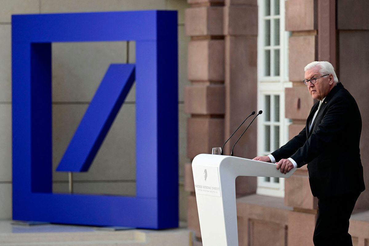 German President Frank-Walter Steinmeier stands next to a Deutsche Bank logo as he gives the laudatio for German Holocaust survivor Margot Friedlaender (not in picture) as she is awarded the Walther-Rathenau-Prize for her outstanding foreign policy lifetime achievement, on July 4, 2022 in Berlin. (Photo by John MACDOUGALL / AFP)