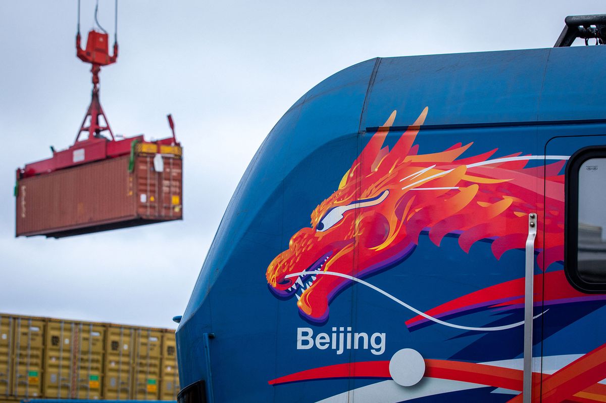 First ship of a new Silk Road arrives, 11 February 2022, Mecklenburg-Western Pomerania, Mukran: A container is unloaded behind a locomotive with an Asian dragon head and the lettering "Beijing" after the arrival of the first ship of a new "Silk Road" connection between China and Germany at the port of Mukran. The containers from Wuhan in China cover part of the route by water and are reloaded onto rail cars on the island of Rügen. Photo: Jens Büttner/dpa-Zentralbild/dpa (Photo by JENS BUTTNER / dpa-Zentralbild / dpa Picture-Alliance via AFP)