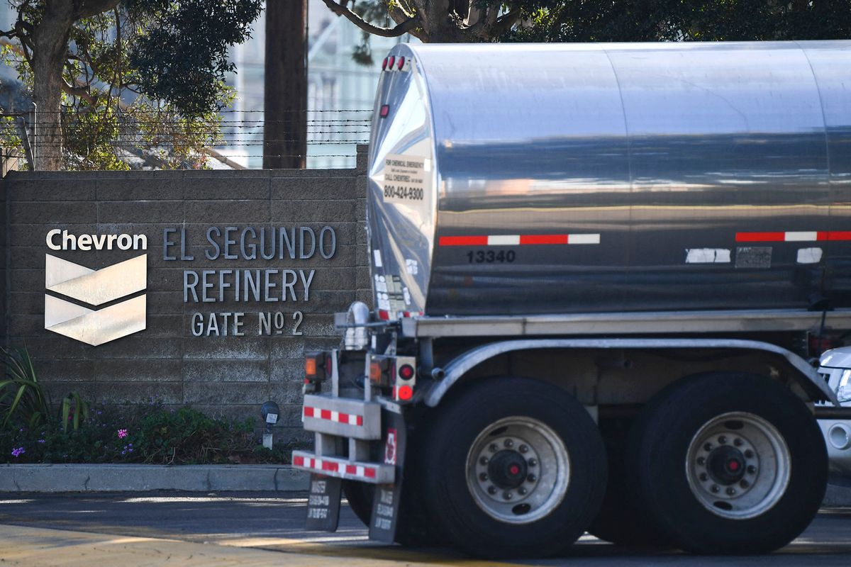 The Chevron logo is displayed as a tanker truck enters the Chevron Products Company El Segundo Refinery on January 26, 2022 in El Segundo, California. - The oil refinery supplies motor vehicle fuels including gasoline and diesel to Southern California as well as jet fuel for aircraft at Los Angeles International Airport (LAX). (Photo by Patrick T. FALLON / AFP)