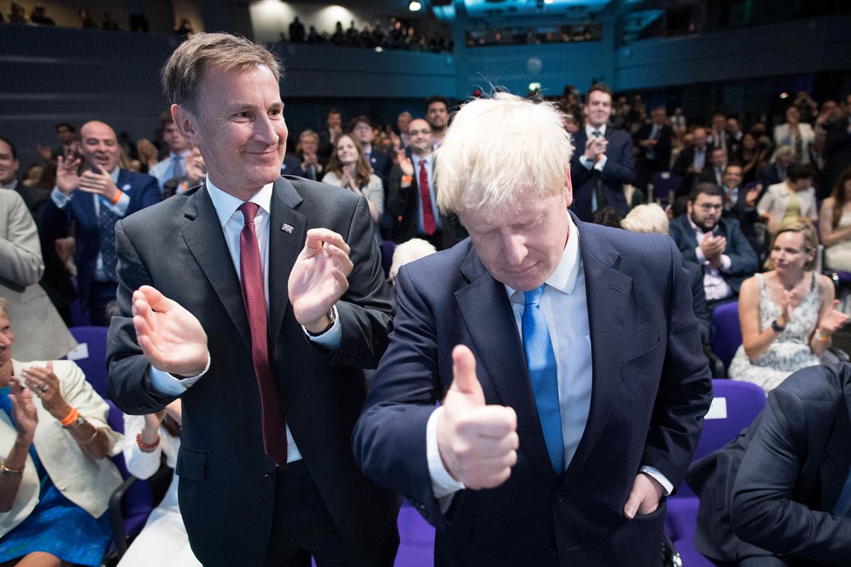New Conservative Party leader and incoming prime minister Boris Johnson (R) stands and gives a tumbs up as he prepares to take the stage to give his acceptance speech after the results of the leadership contest against fellow contender Jeremy Hunt (L) are announced at an event in central London on July 23, 2019. - Boris Johnson won the race to become Britain's next prime minister on Tuesday, heading straight into a confrontation over Brexit with Brussels and parliament, as well as a tense diplomatic standoff with Iran. (Photo by Stefan Rousseau / POOL / AFP)