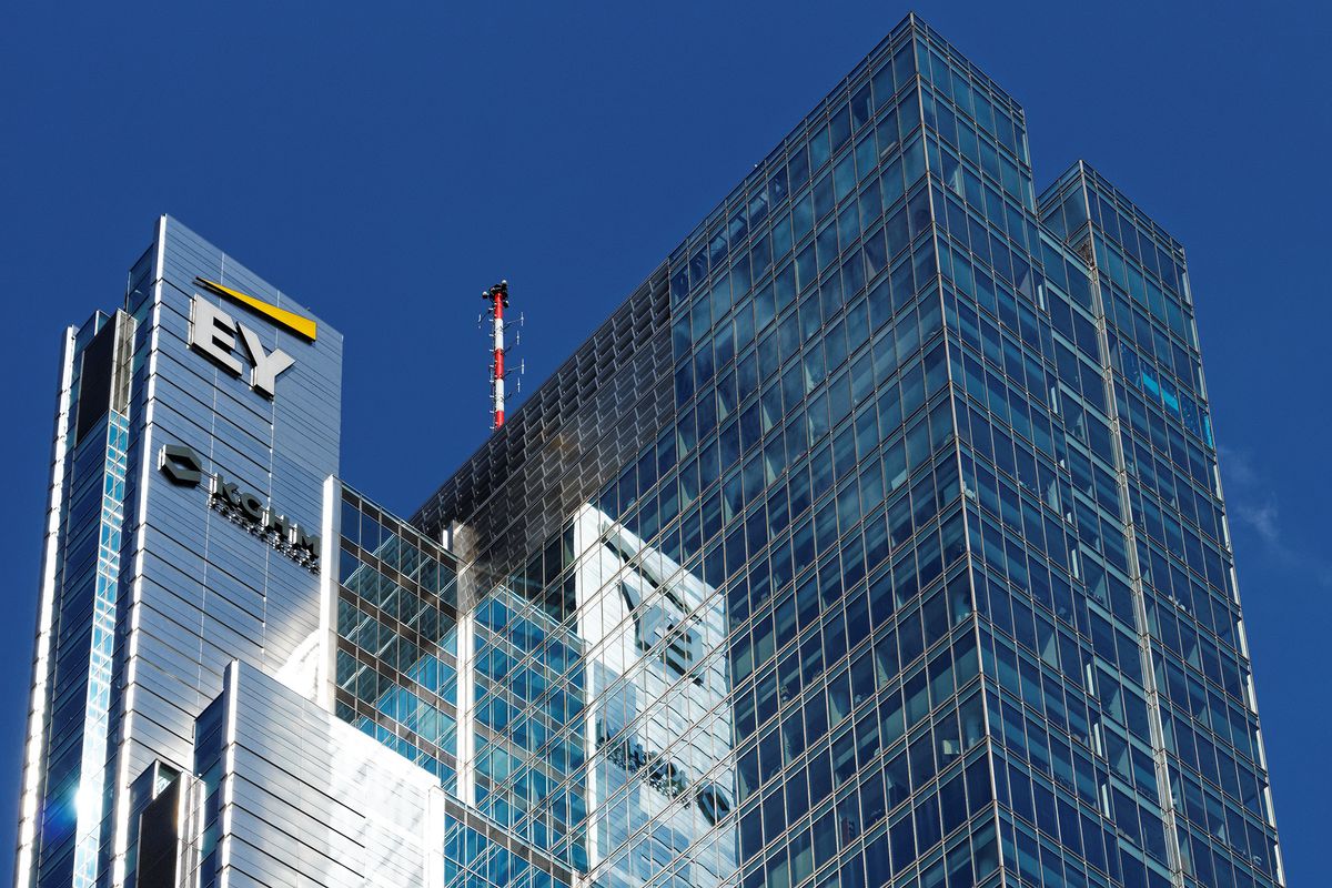 Warsaw/Poland - April 8, 2018: EY (Ernst&Young) and KGHM logotypes reflected in glass facade of office buildings