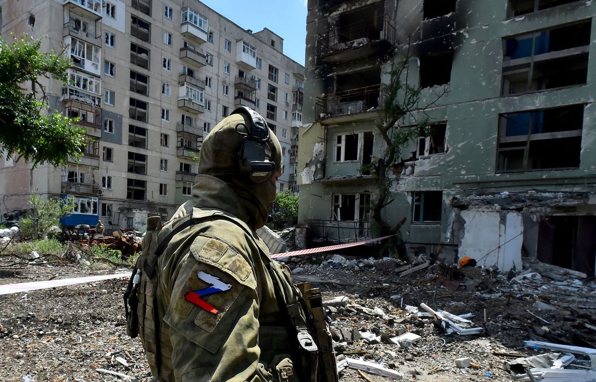 A Russian serviceman patrols a destroyed residential area in the city of Severodonetsk on July 12, 2022, amid the ongoing Russian military action in Ukraine. (Photo by Olga MALTSEVA / AFP)