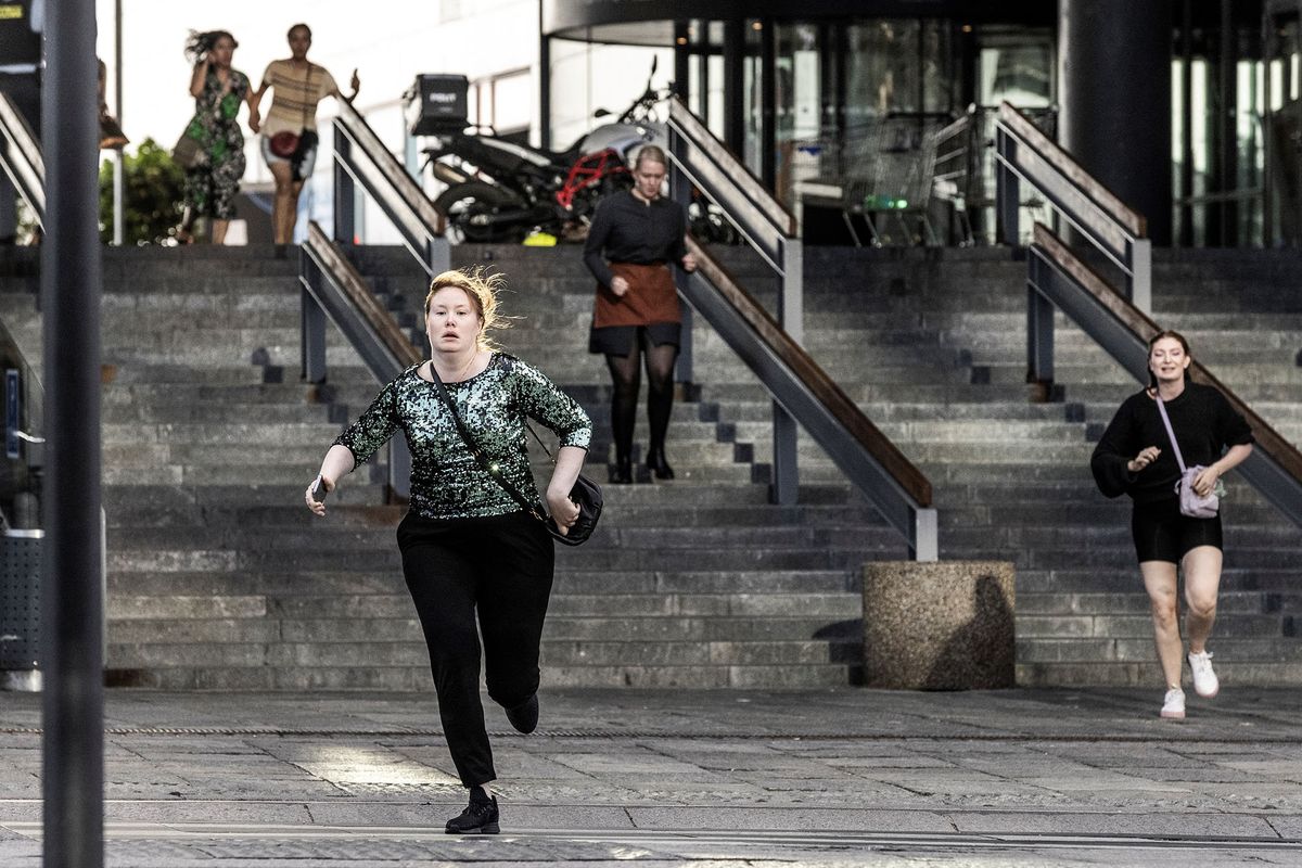 People run during the evacuation of the Fields shopping mall, where a gunman killed three people and wounded several others in Copenhagen, Denmark, on July 3, 2022. - A 22-year-old Danish man was arrested after the shooting but his motives were unclear, police said. (Photo by Olafur STEINAR GESTSSON / Ritzau Scanpix / AFP) / Denmark OUT