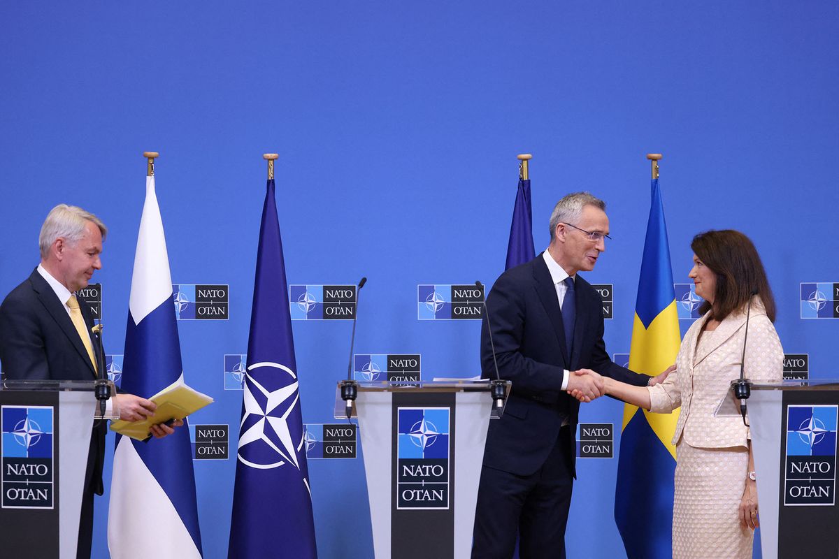 Swedish Ministry for Foreign Affairs Ann Linde (R) shakes hands with NATO Secretary General Jens Stoltenberg (C) as Finnish Foreign Minister Pekka Haavisto (L) looks on following a press conference at the NATO headquarters in Brussels on July 5, 2022. - The process to ratify Sweden and Finland as the newest members of NATO was formally launched on July 5, 2022, the military alliance's chief Jens Stoltenberg said, marking a historic step brought on by Russia's war in Ukraine. (Photo by Kenzo TRIBOUILLARD / AFP)