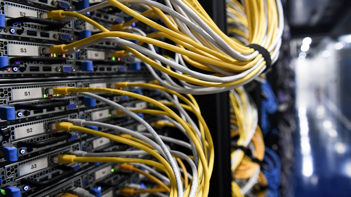 A photograph taken on July 9, 2021 shows cables and serveres in the computers room at the Scaleway data center a subsidiary of the French Free wireless service provider group, in Saint-Ouen-l'Aumone. (Photo by ALAIN JOCARD / AFP)