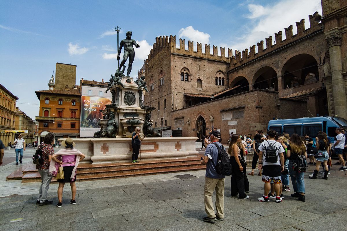 People and tourist are seen in front of Nettuno fountain in Piazza Maggiore square in Bologna, Italy, on May 25, 2022. (Photo by Lorenzo Di Cola/NurPhoto) (Photo by Lorenzo Di Cola / NurPhoto / NurPhoto via AFP)