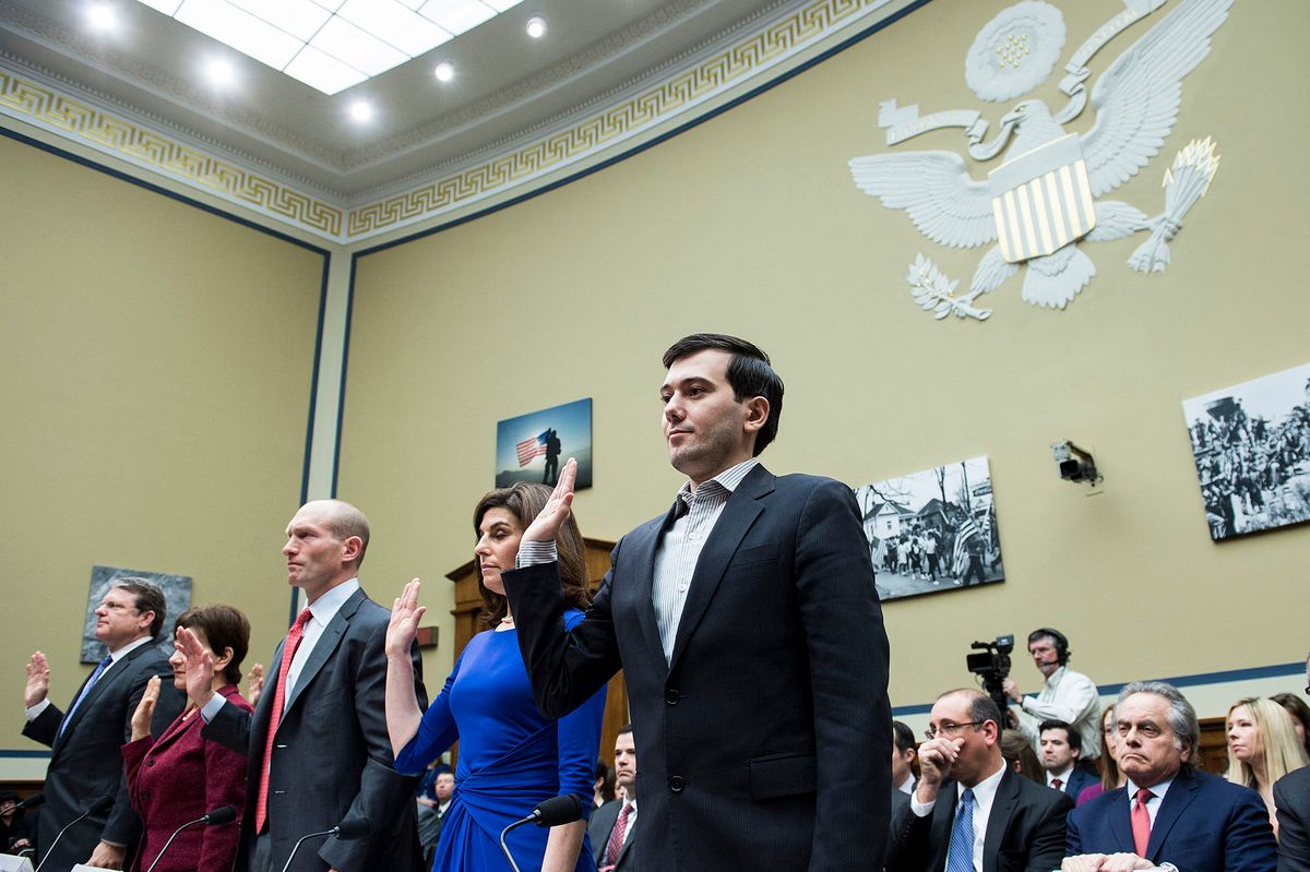 Entrepreneur and pharmaceutical executive Martin Shkreli (R) is sworn in with others during a hearing of the House Oversight and Government Reform Committee on Capitol Hill February 4, 2016 in Washington, DC. - Martin Shkreli, the controversial former pharmaceuticals boss and hedge fund manager indicted on securities fraud charges, has been subpoenaed to appear at a hearing of a House of Representatives committee on oversight and government reform looking at the prescription drug market. (Photo by Brendan Smialowski / AFP)