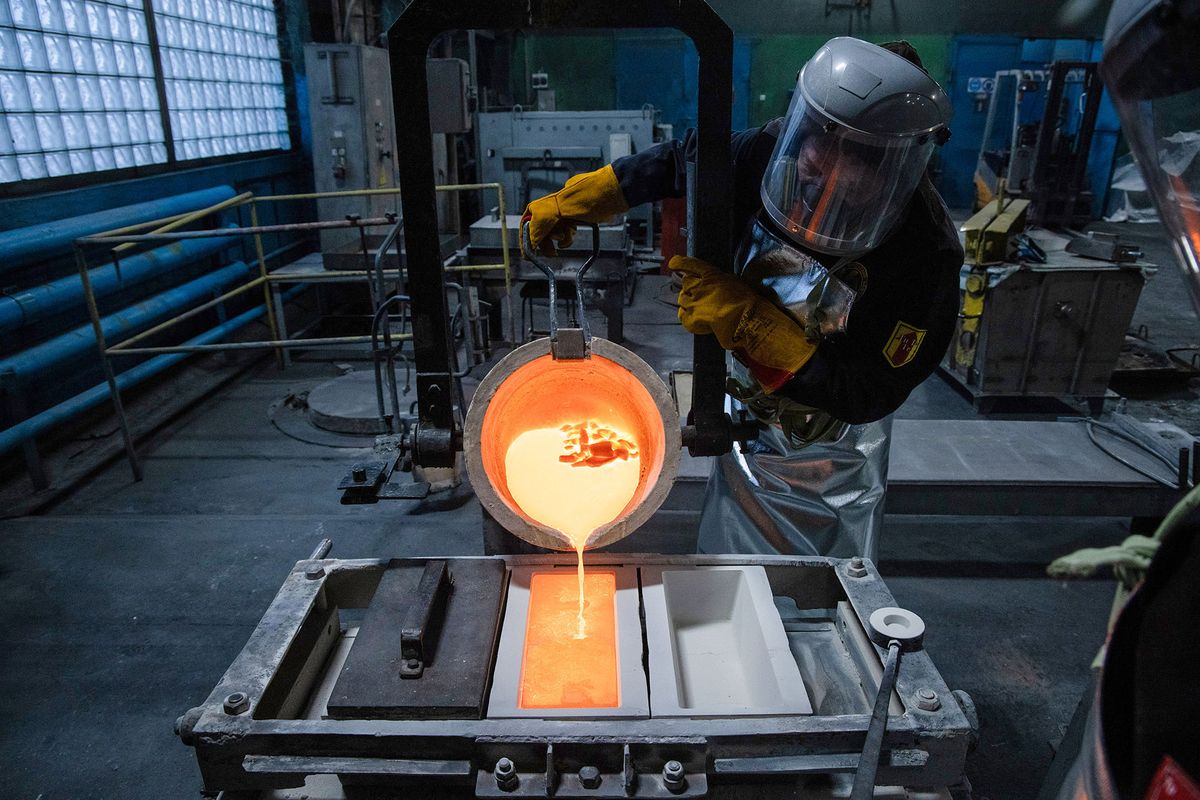 1237140128 A worker pours molten silver into a mold during the casting of silver ingots in the foundry at the Prioksky non-ferrous metals plant in Kasimov, Russia, on Thursday, Dec. 9, 2021. Bullion is heading for its first annual drop in three years as central banks start to dial back on pandemic-era stimulus. Photographer: Andrey Rudakov/Bloomberg via Getty Images