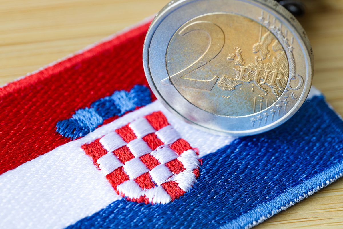 Croatian flag next to the 2-euro coin. Concept of Croatia joining the Euro zone, Political and economic concept of the European Union