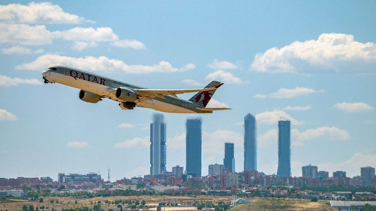 1241092145 MADRID, SPAIN - 2022/06/03: Qatar Airways airplane takes off from Madrid Adolfo Suarez Airport passing by the skyscrapers of the business area of Madrid. (Photo by Marcos del Mazo/LightRocket via Getty Images)