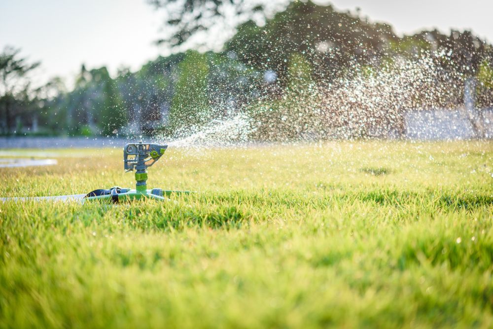 Sprinkler,On,The,Grass,Field