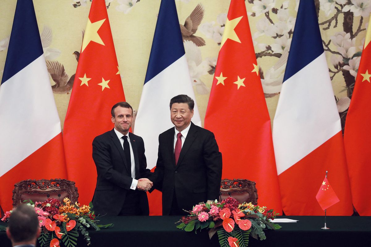 French President Emmanuel Macron (L) shakes hands with Chinese President Xi Jinping following a signing ceremony at the Great Hall of the People in Beijing on November 6, 2019. (Photo by Ludovic MARIN / AFP)