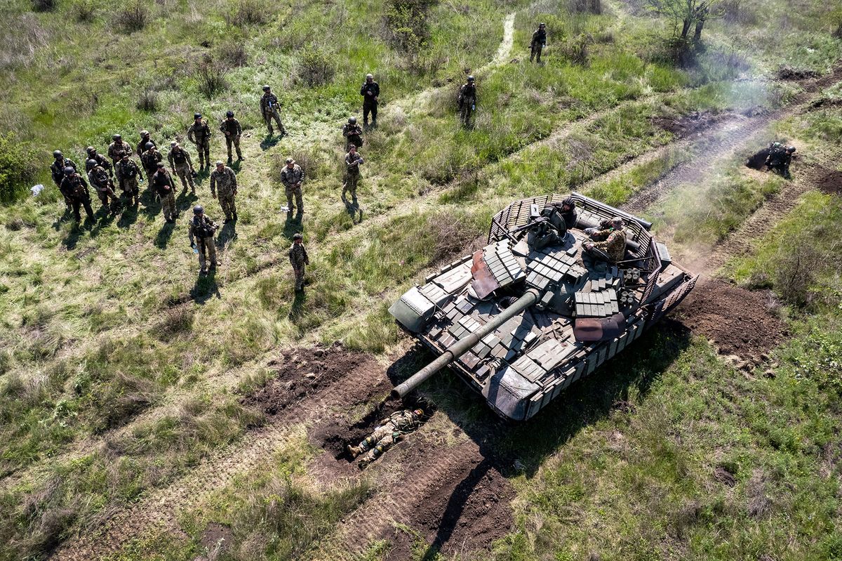 Ukrainian Army Tanks And Infantry Train Near Southern Front, Dnipropetrovsk Oblast, UKRAINE - MAY 09: In this aerial view, A Ukrainian Army tank drives over an infantryman during a training exercise on May 09, 2022 near Dnipropetrovsk Oblast, Ukraine. Infantry soldiers learned scenarios to survive when potentially confronted with a Russian tank closing in at close range. The frontline with Russian troops lies only 70km to the south in Kherson Oblast, most of which is controlled by Russia. (Photo by John Moore/Getty Images)
