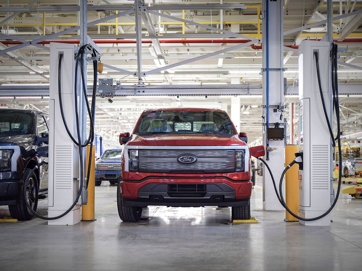 This handout photo released by Ford Motor Company on April 26, 2022 shows the F-150 Lightning at a charging station in the Rouge Electric Vehicle Center in Dearborne, Michighan. - Today marks the launch of the all-new, electric F-150 Lightning pickup ñ a milestone moment in Americaís shift to electric vehicles. (Photo by FORD MOTOR COMPANY / AFP)