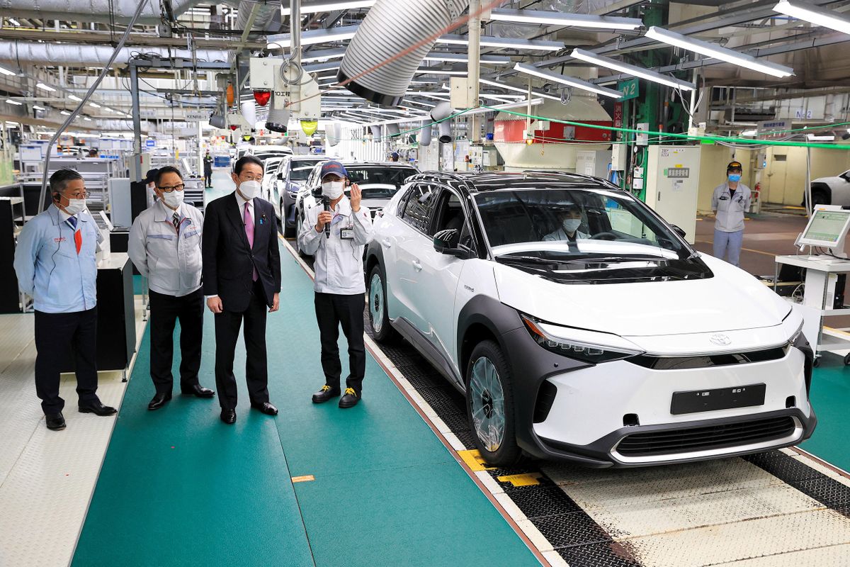 Japanese Prime Minister Fumio Kishida (2nd from R), guided by Akio Toyoda (2nd from L), CEO and President of Toyota Motor Corp., visits the Motomachi Plant to inspect electric vehicle (EV) and Fuel Cell Vehicle (FCV) in Toyota City, Aichi Prefecture on June 17, 2022.    ( The Yomiuri Shimbun ) (Photo by Pool for Yomiuri / Yomiuri / The Yomiuri Shimbun via AFP)